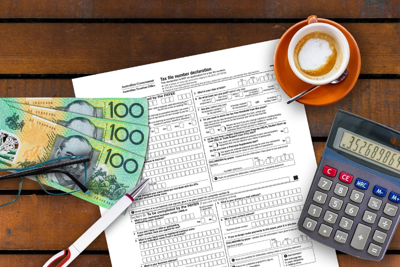 Australian tax file declaration form with cash and calculator for property investment tax planning