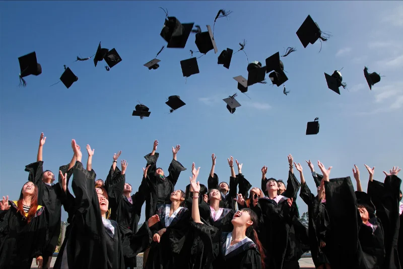 Graduating students celebrating college acceptance