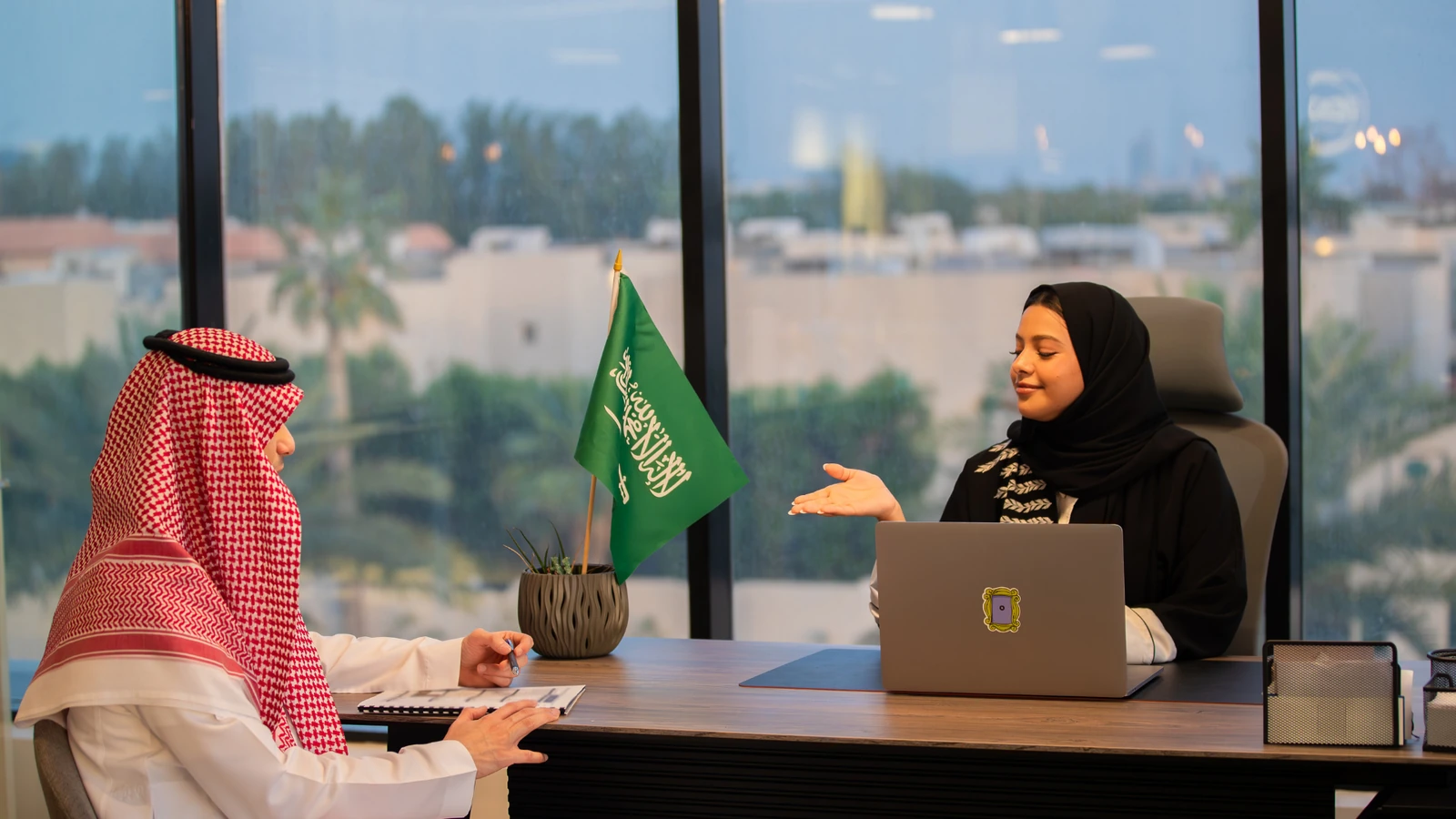 Business meeting in a Saudi Arabia office with the national flag